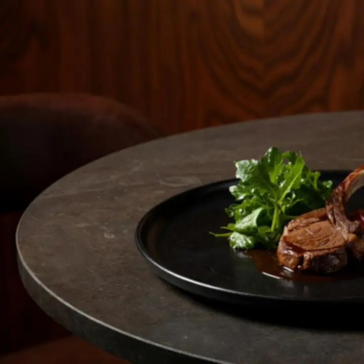 A cinematic spread of contemporary Australian gourmet dishes presented in a luxury restaurant setting.