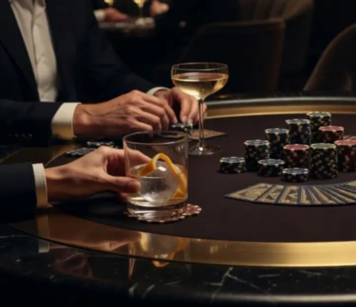 Elegant poker lounge with premium tables, cards and guests enjoying a social poker night at TheAceAndEmber.